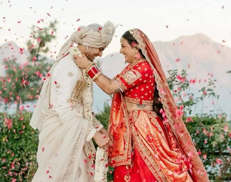 Vibrant outdoor wedding venue decorated with colourful tents and floral arrangements